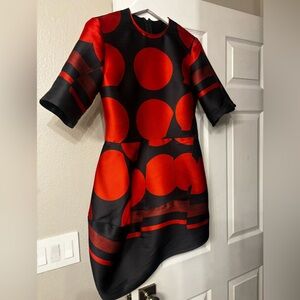 An elegant designer satin dress in a striking red and dark blue color combo.